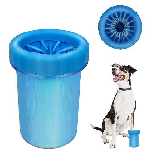 Blue paw cleaner cup with soft silicone bristles inside, next to a seated dog